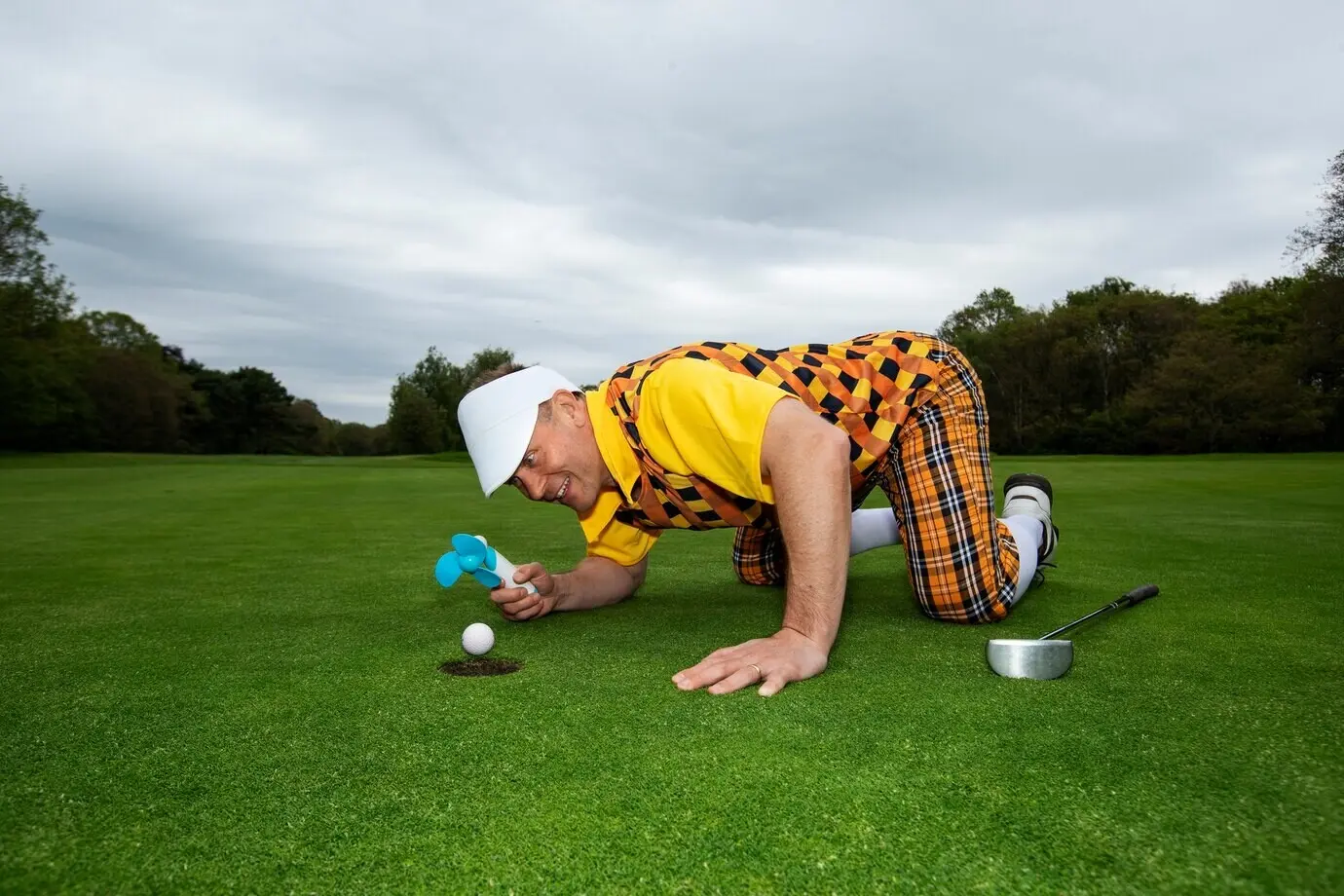 A man playing golf on an outdoor course
